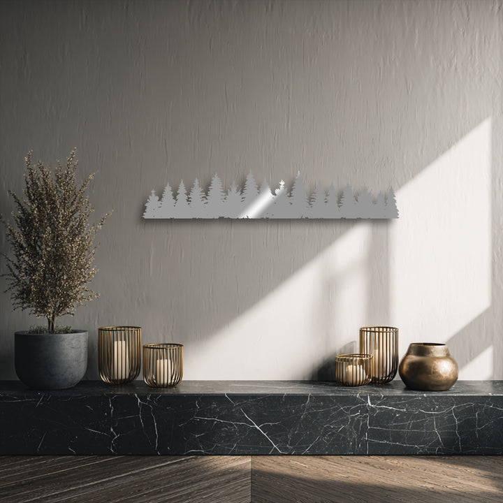 A gentle, soft reflection highlights the intricate details of the pine forest silhouette metal artwork, adding a luminous sheen.