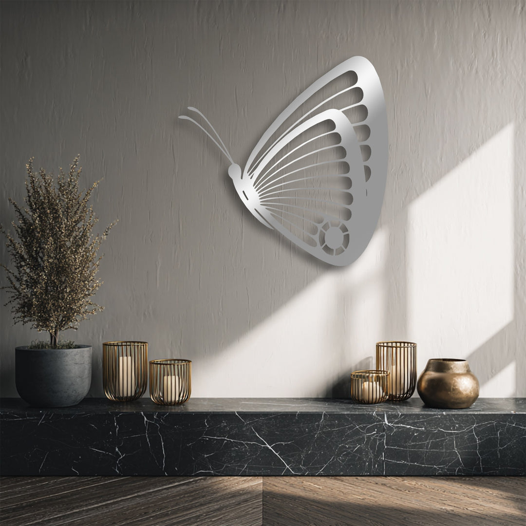 The textured greige background wall with natural light and subtle shadows beautifully highlights the metal butterfly decoration wall art.