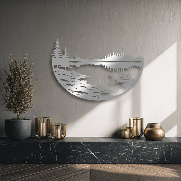 Soft sunlight illuminates the textured wall, casting gentle shadows that complement the serene unique metal wall art depicting a peaceful fishing lake.