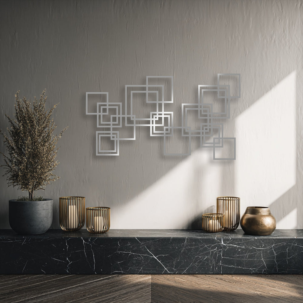 Dramatic light and shadow highlight the three-dimensional interlocking squares metal art for wall, creating a captivating modern geometric design.