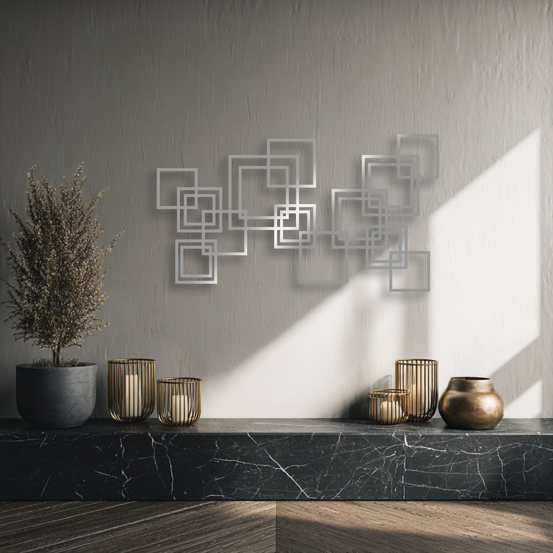 Dramatic light and shadow highlight the three-dimensional interlocking squares metal art for wall, creating a captivating modern geometric design.