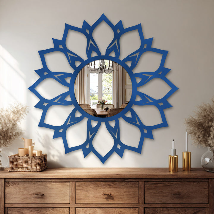Vibrant color saturation highlights the royal blue of this lotus pattern modern mirror, making it a captivating piece of decorative metal art above the wooden console.