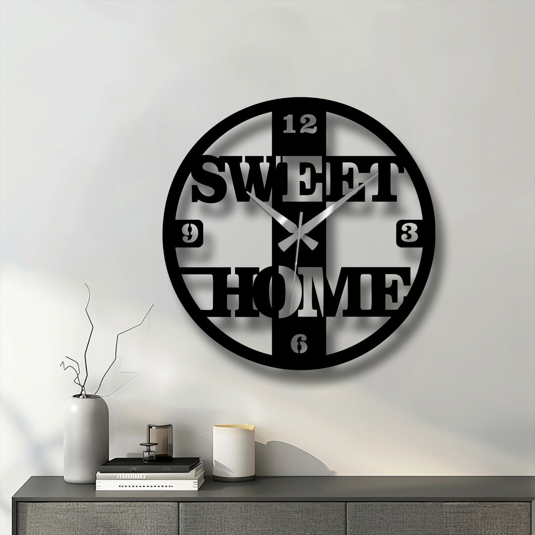 Featuring an edge and borders, the sweet home decorative metal art clock showcases a modern, round design with prominent numerals and lettering.