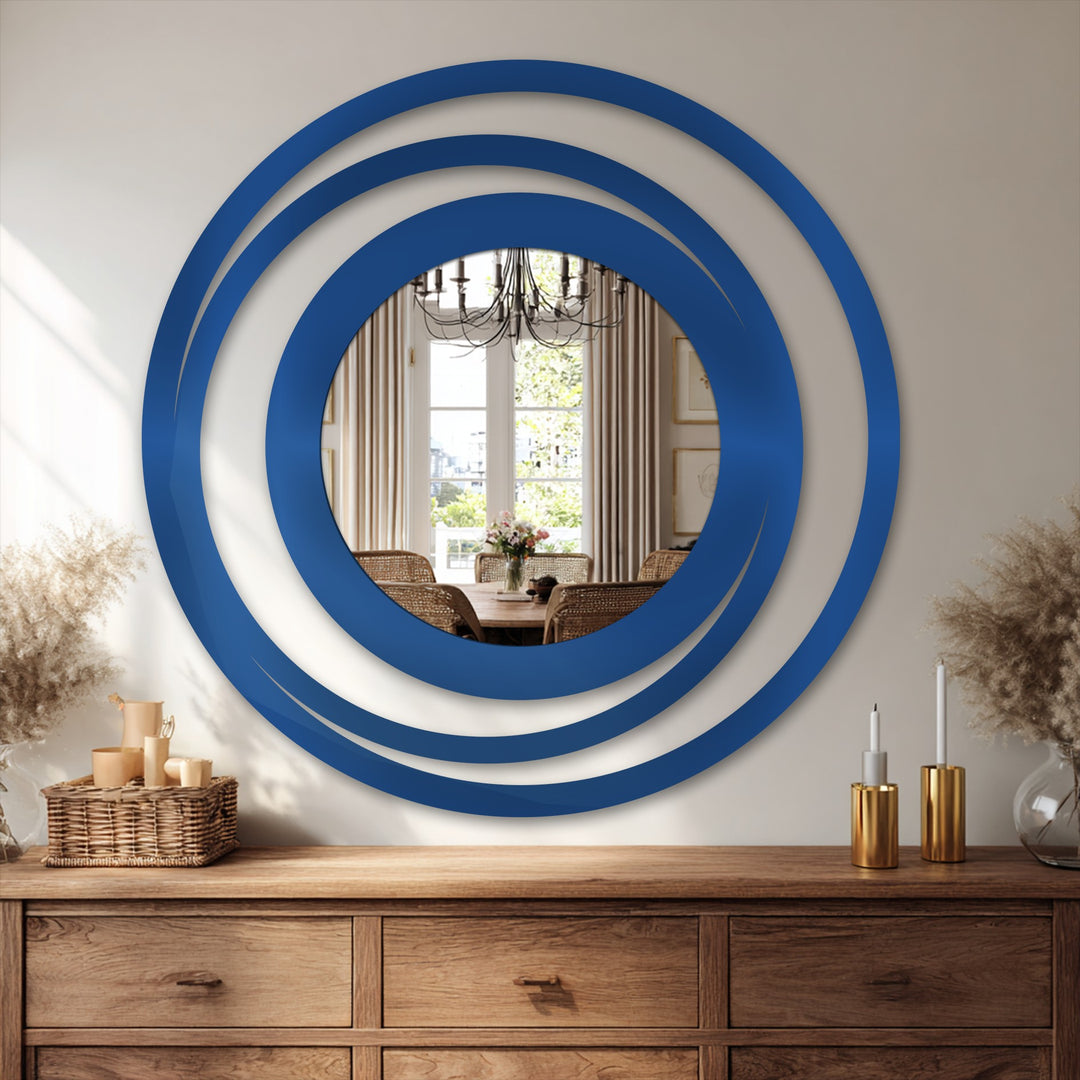 Shadows define the layered metal artwork of the Orbit Ring Floor Mirror, creating depth in the circular design with a modern metal frame.