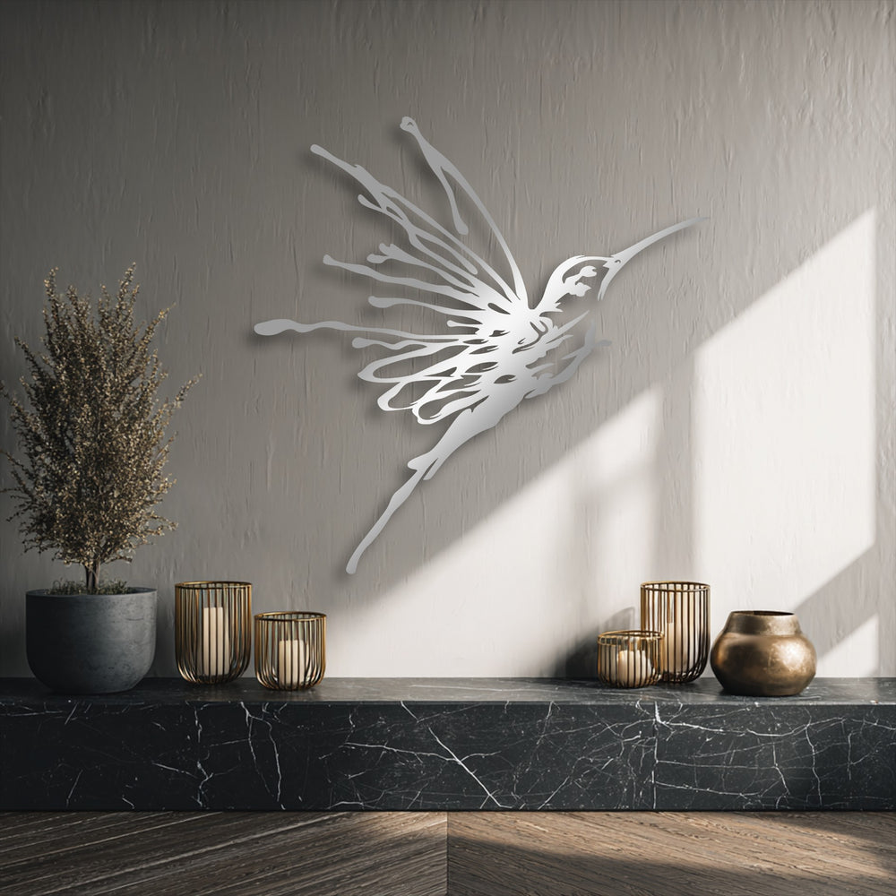 The sleek metallic finish of this decorative metal art piece beautifully highlights the elegant flying hummingbird.