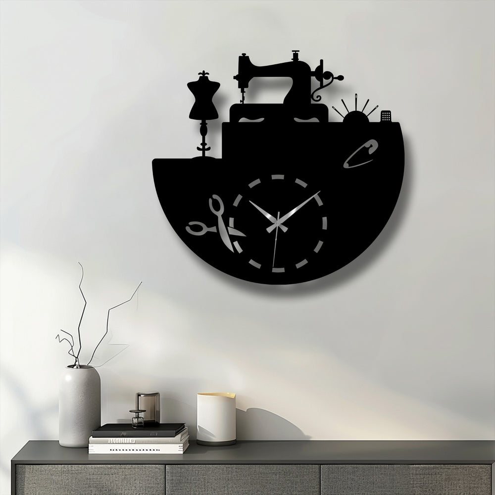 The sharp edges and distinct borders of the black metal wall decor beautifully outline the tailor studio inspired sewing clock design.