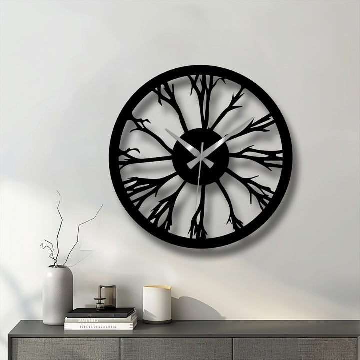 The focal point highlights the intricate tree silhouette design of this black metal wall clock, offering a stunning piece of decoration wall art with its modern nature-inspired aesthetic.