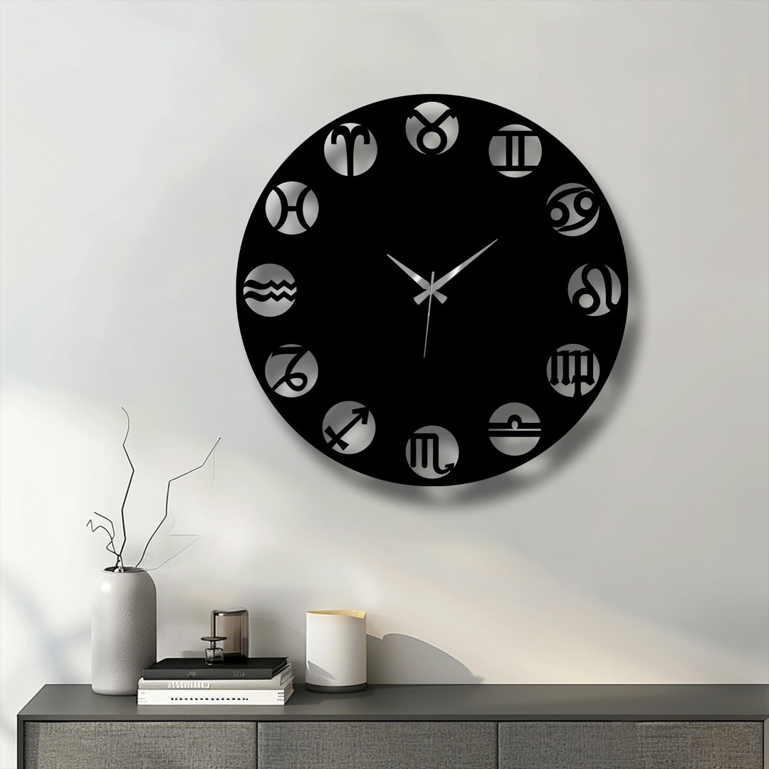 A cool, crisp light illuminates a sleek black Zodiac Symbol Metal Wall Clock, showcasing its modern astrological metal wall decor.