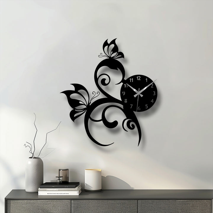 The elegant metal art for wall, a butterfly vine clock, showcases a striking transition from the stark black design to subtle gray shadows on the white background.