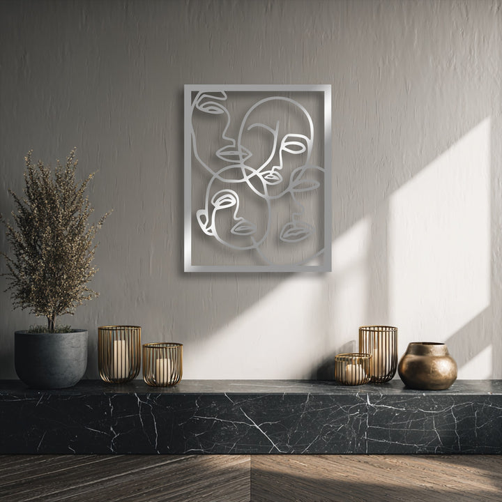 The foreground features a dark marble surface, a potted plant, brass candle holders, and a vase, enhancing the metal art for wall.