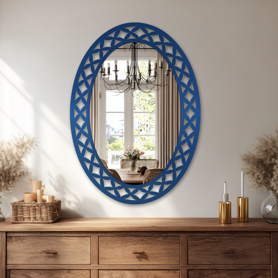 Warm color temperature dominates this oval floor mirror with a decorative metal art geometric petal frame, reflecting soft neutral tones within a sunlit interior.