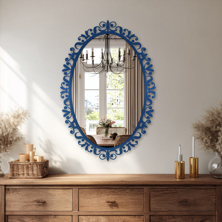 Visible through the ornate floral scrollwork framed wall mirror is a dining room with a chandelier and table setting, complementing the decoration wall art.