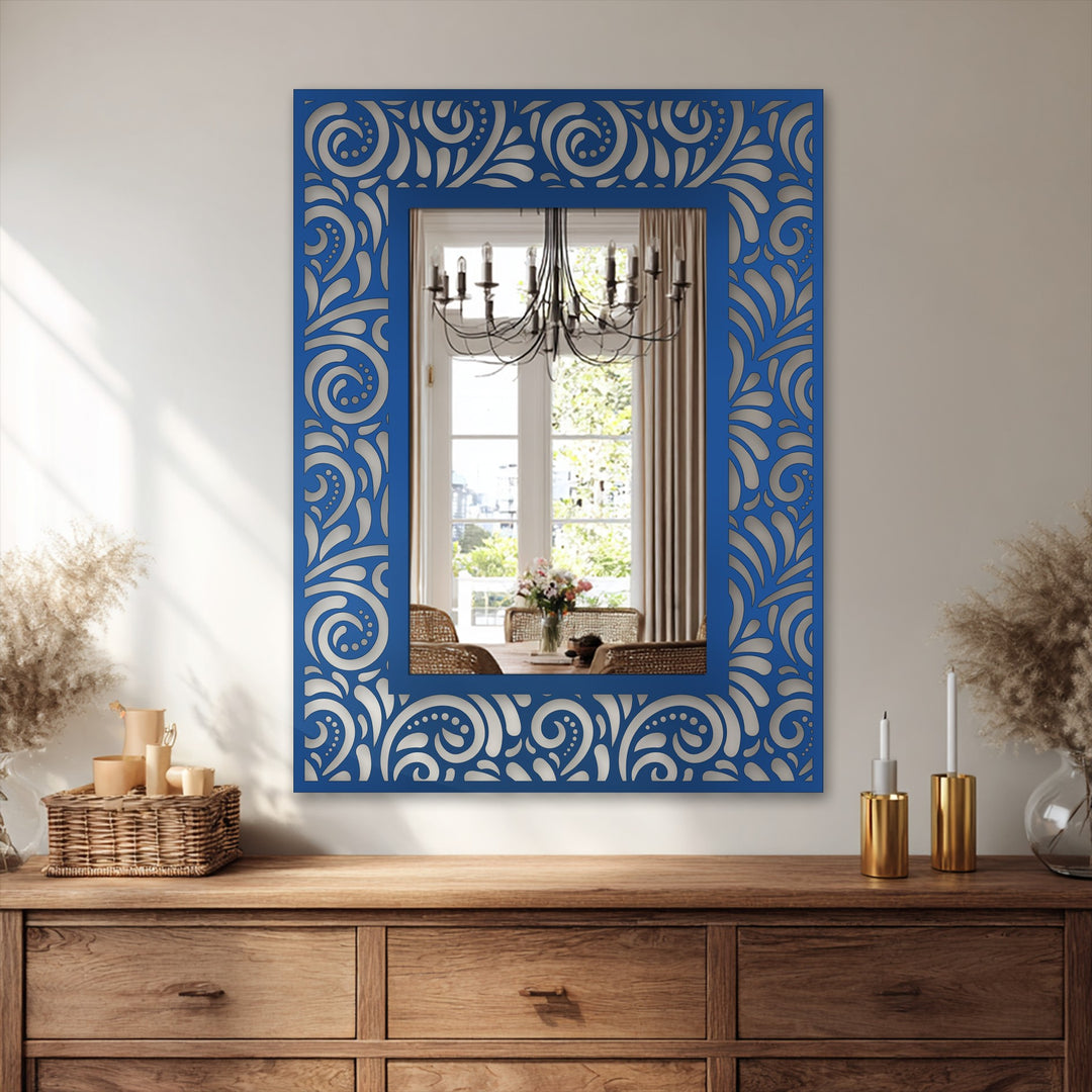 Neutral color temperatures highlight the ornate floral scroll pattern on this mirror for wall decor, enhanced by the reflection's chandelier and warm wood tones.