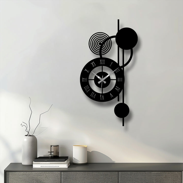 Black dominates this modern orbit metal wall clock featuring a unique modern wall decor design of circles, Roman numerals, and vertical abstract shapes.