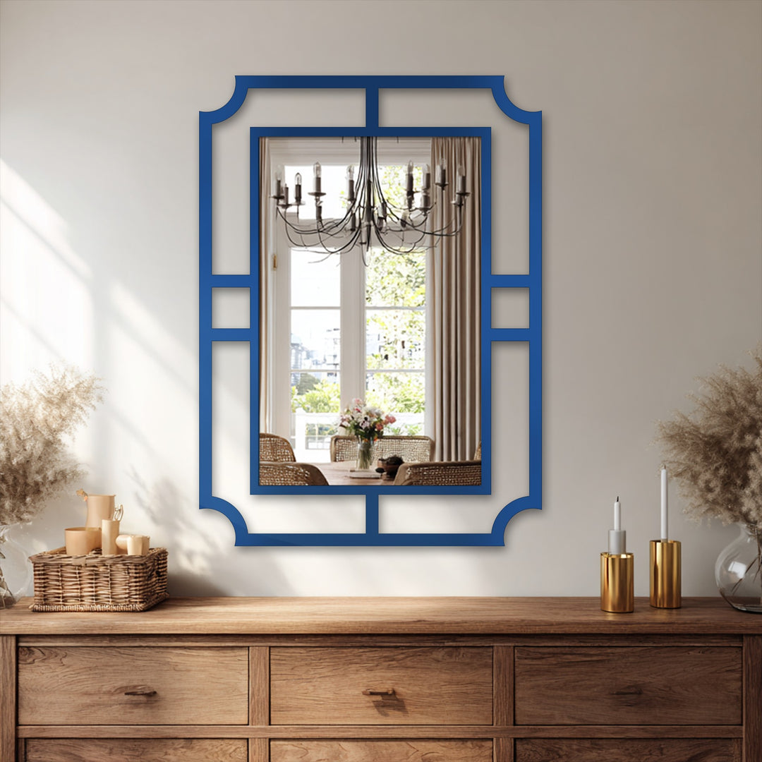 Shadows emphasize the geometric frame of the decorative metal art wall mirror, a minimalist statement design casting depth against the lighter wall.