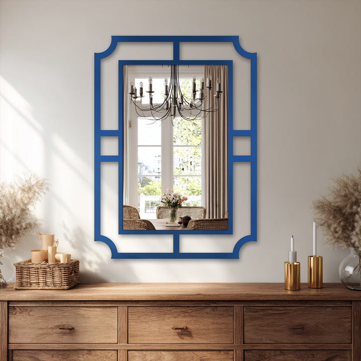 Shadows emphasize the geometric frame of the decorative metal art wall mirror, a minimalist statement design casting depth against the lighter wall.