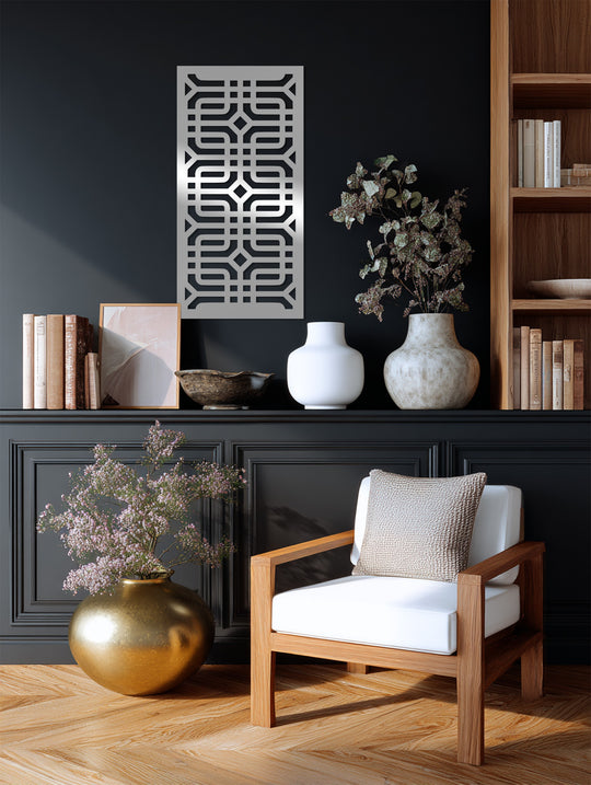 Desaturated silver geometric maze metal artwork brings a muted elegance to the room, contrasting with the deep, almost monochromatic wall color, and highlighting the rich wood tones.