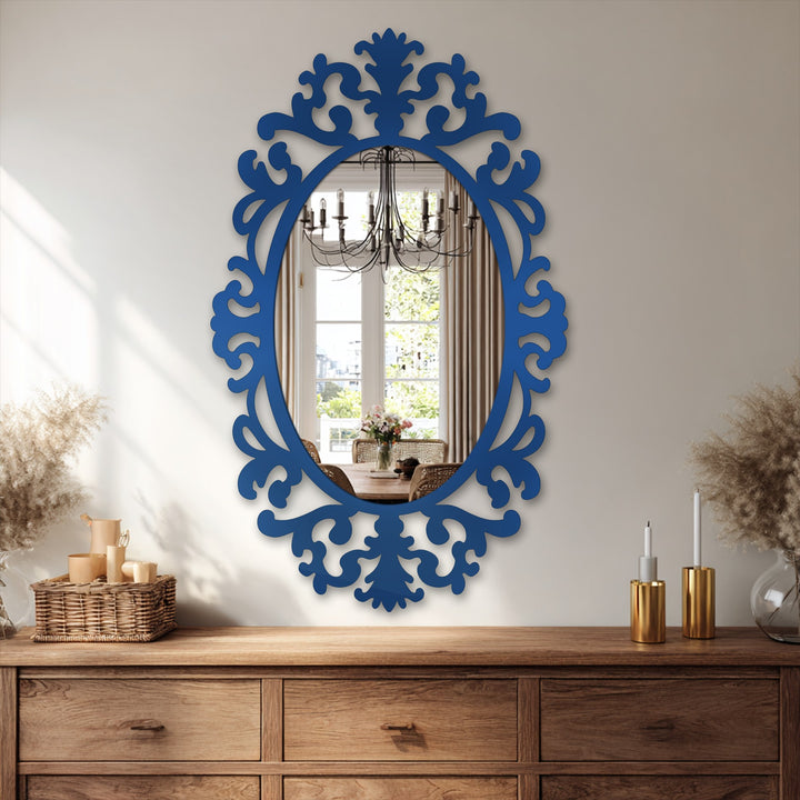 Bright wall highlights the azure frame of the oval mirror for wall decor, contrasting with the warm wood dresser beneath.