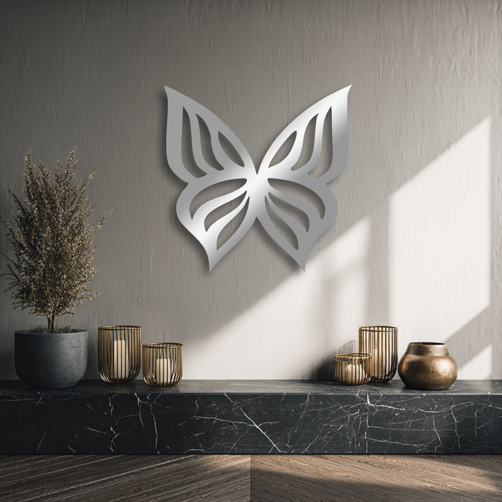 The loudest element is an elegant, large metallic butterfly silhouette, serving as captivating decoration wall art above a black marble shelf.