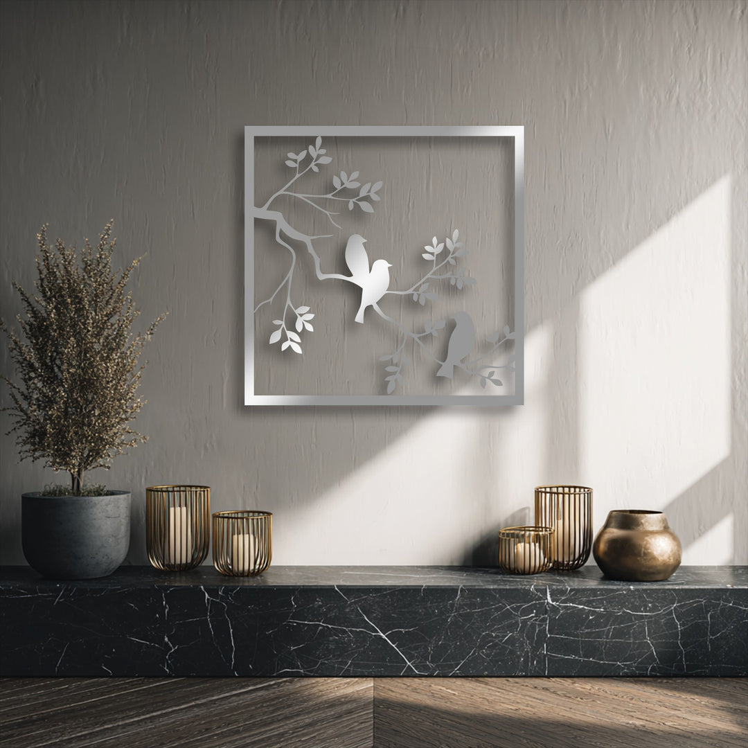 The layering effect of this decorative metal art creates a striking minimal nature silhouette of birds on a branch within a frame.