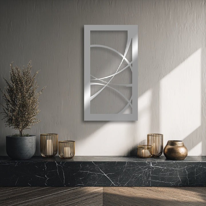 The serene and modern mood of a room is enhanced by a geometric unique metal wall art piece, complemented by warm metallic accents and natural light.