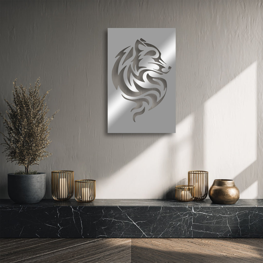 Dramatic sunlight and sharp shadows accentuate the shimmering tribal wolf metal artwork, emphasizing its abstract design on a textured gray wall.