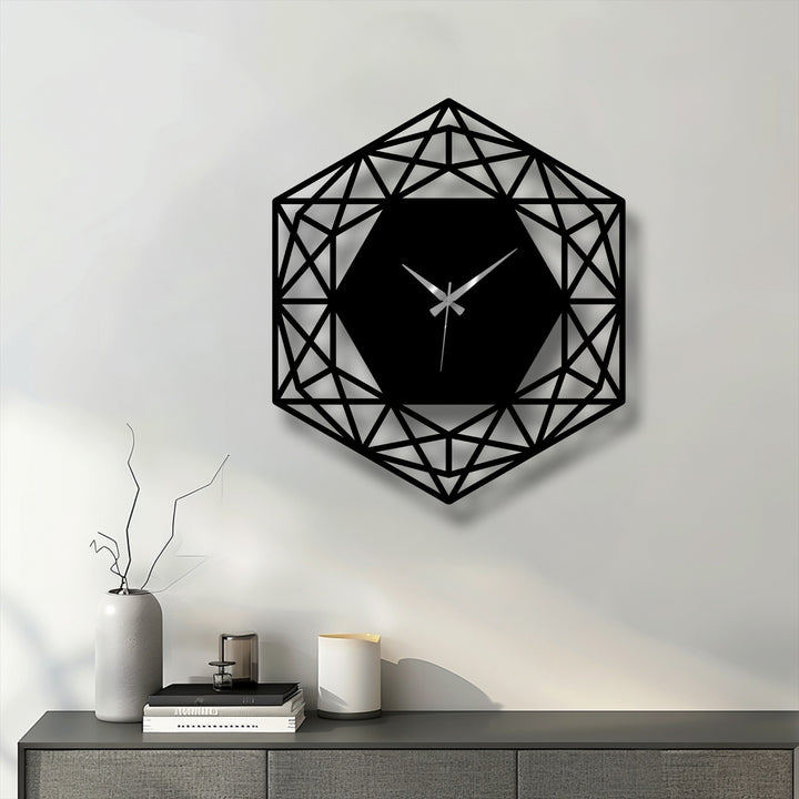The bold, black geometric hexagon metal wall clock with its intricate design serves as unique metal wall art, casting a shadow on the light wall.
