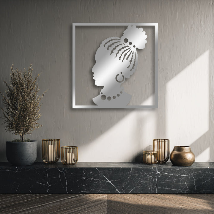 The pronounced color contrast between the radiant silver African woman silhouette metal decoration wall art and the warm, textured wall under sunlight.