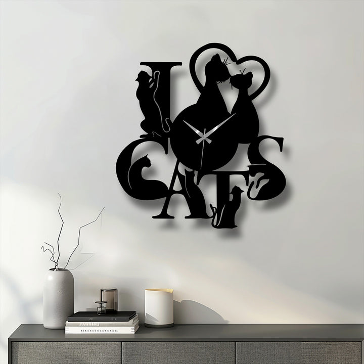 The brightest area showcases a sleek 'Love Cats' metal art for wall clock with cat silhouettes casting subtle shadows against a pristine white background.