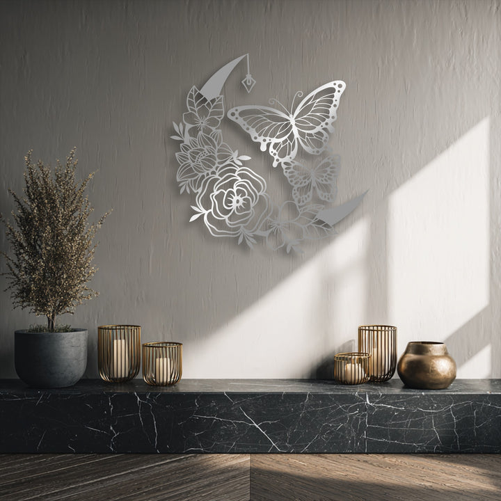 Negative space on the wall sharply outlines the elegant floral moon and butterfly decorative metal art, enhanced by contrasting shadows and light.