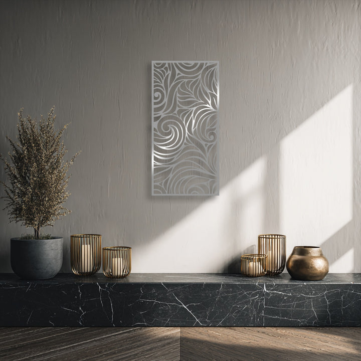 The background features a subtly textured greige wall, enhancing the detailed design of the abstract swirl decorative metal art.