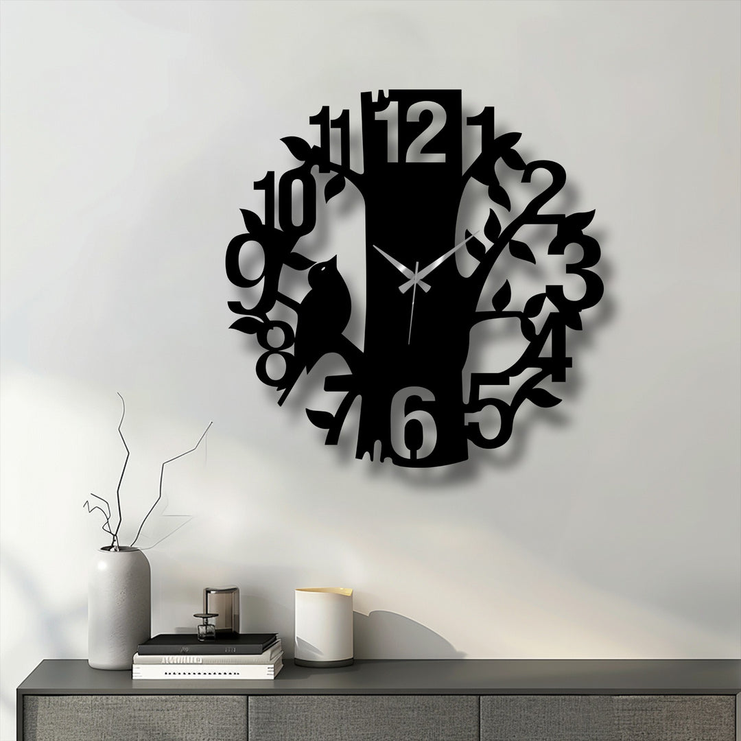 Sharp color contrast defines the sleek black Curious Cat Tree metal wall clock against the light wall, enhancing its nature-inspired metal wall decor.