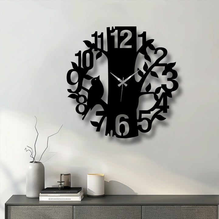 Sharp color contrast defines the sleek black Curious Cat Tree metal wall clock against the light wall, enhancing its nature-inspired metal wall decor.