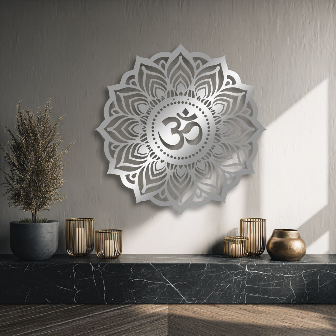 The image showcases the varied surface texture of a textured wall, smooth Om Mandala metal artwork, a dried plant, and a veined marble shelf.