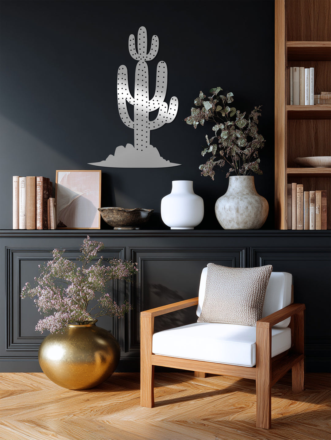 In the foreground, the golden vase and plush chair complement the Saguaro Cactus unique metal wall art on the panelled wall.