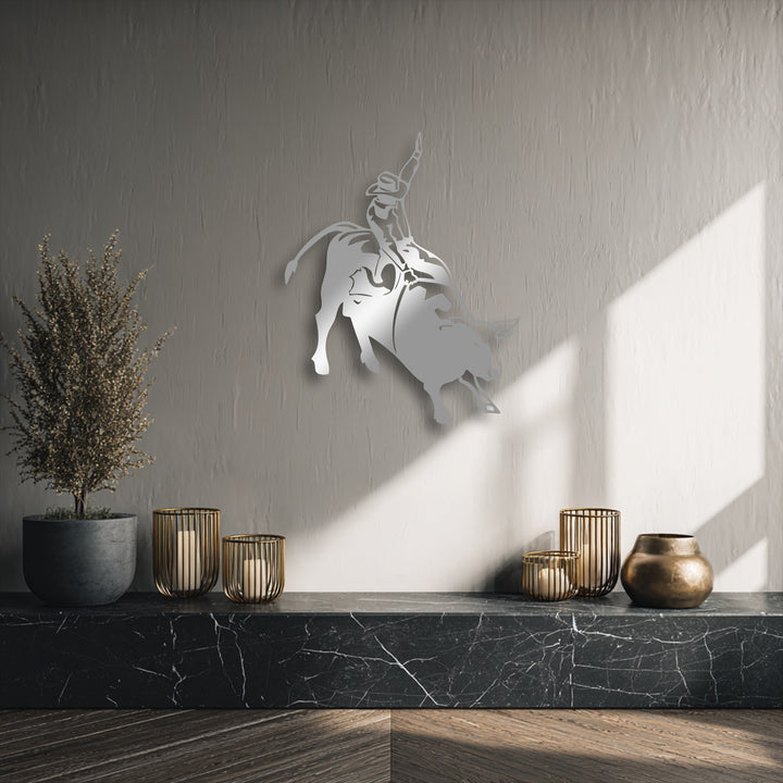 The visual rhythm of the unique metal wall art, depicting a dynamic rodeo cowboy on a bucking bull, energizes the textured wall.