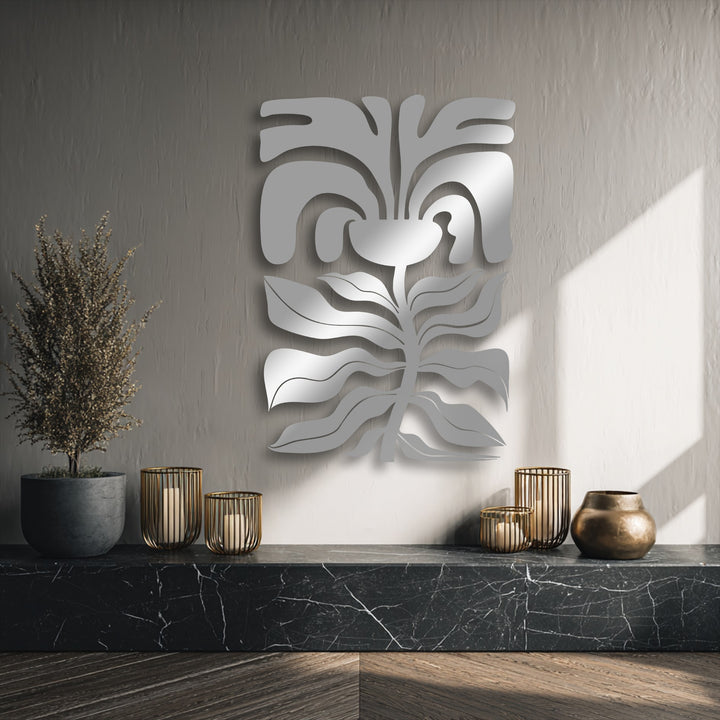 Muted greige walls prominently display abstract floral face metal wall decor, reflecting light over a luxurious black marble surface.