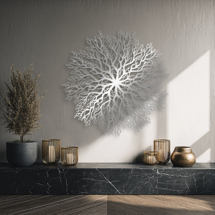 Black marble supports elegant gold candlesticks, a bronze vase, and a dried potted plant in the foreground, complementing the metal art for wall.