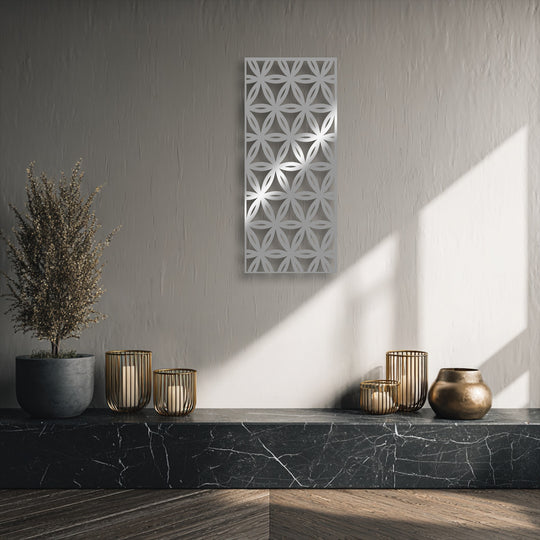 Witness the striking color transition on the textured wall, shifting from deep grey to brilliant sunlit white around the geometric floral metal wall decor.
