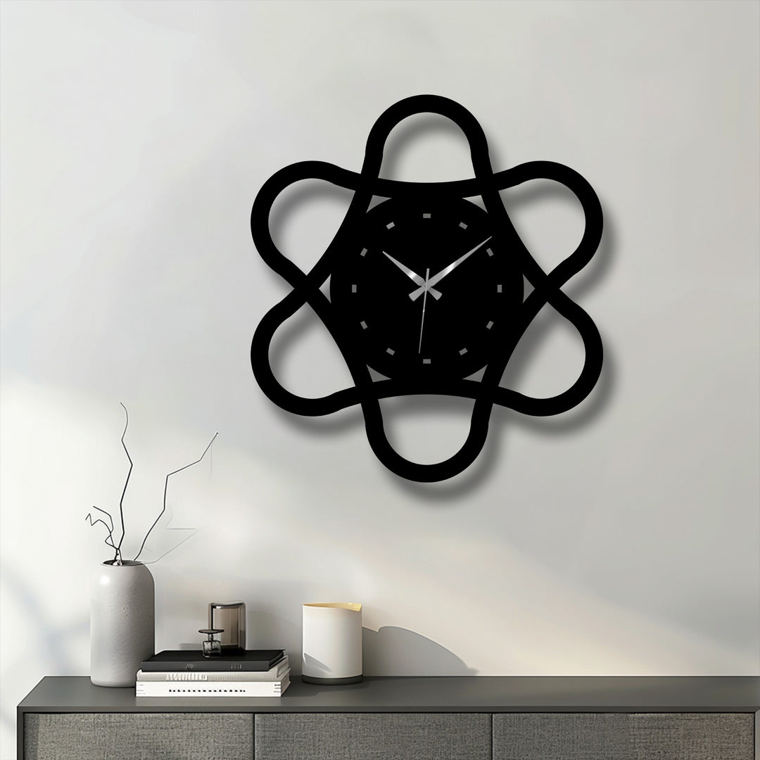 Sharp color contrast highlights the minimal loop geometry metal wall clock's modern abstract design, a striking decoration wall art piece against a light background.