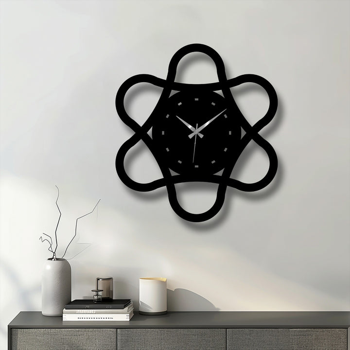 Sharp color contrast highlights the minimal loop geometry metal wall clock's modern abstract design, a striking decoration wall art piece against a light background.