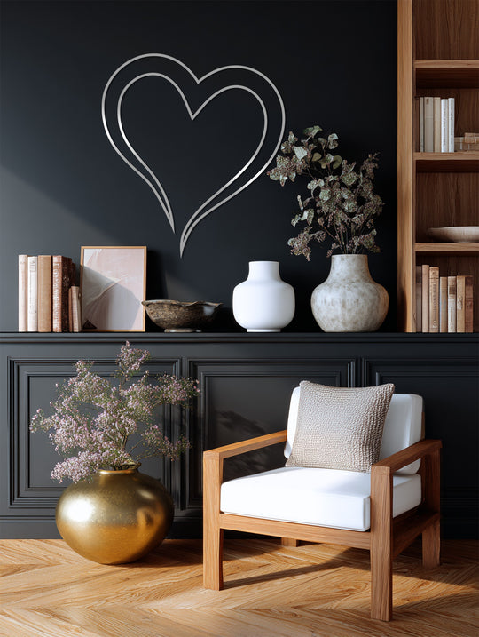 Dark wall highlights the silver double-line heart, a piece of unique metal wall art that adds a modern, minimalist touch to any home decor.