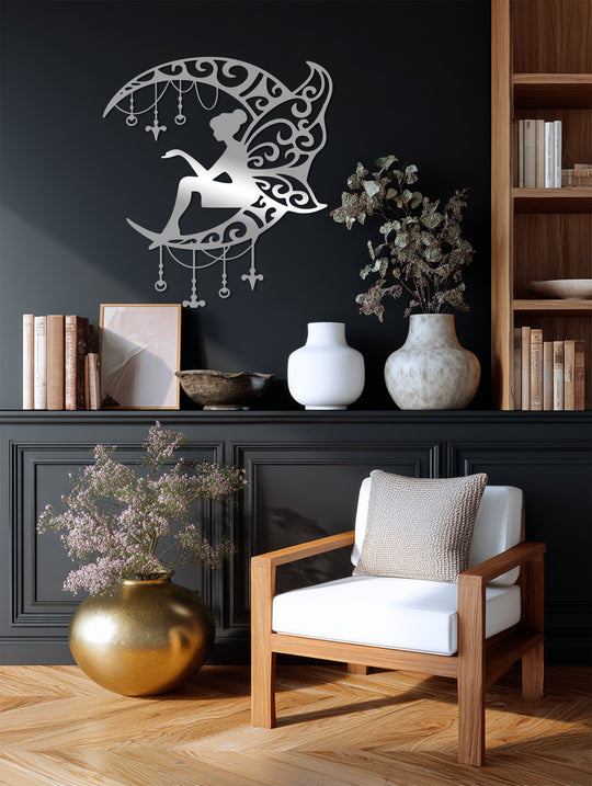 A graceful metal fairy appears to float within this decorative metal wall decor, its delicate wings suggesting a sense of movement around the crescent moon.