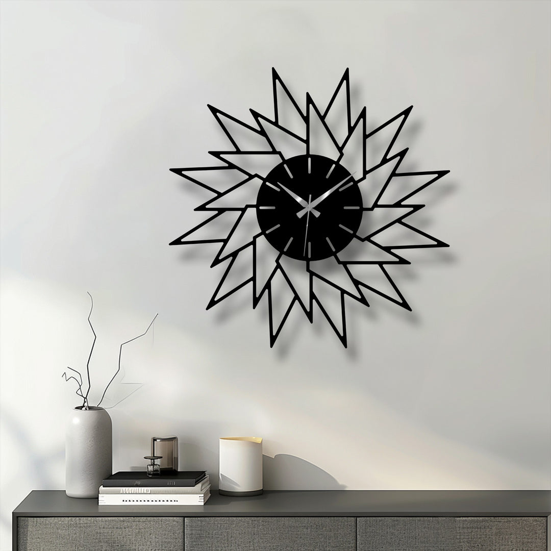 Smooth surface texture highlights the decorative metal art of this abstract starburst wall clock, showcasing its modern, geometric design.