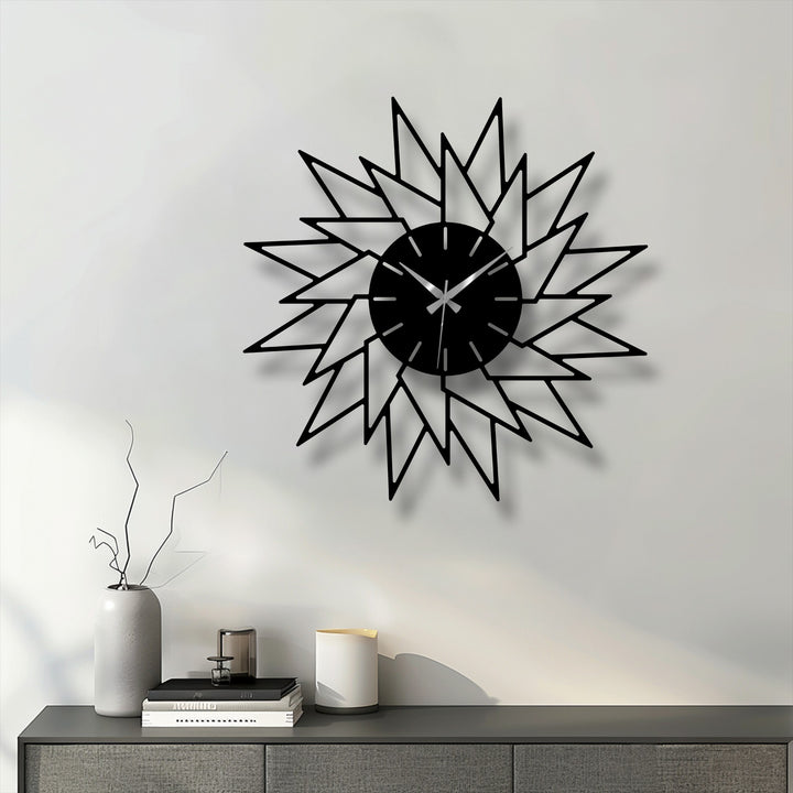 Smooth surface texture highlights the decorative metal art of this abstract starburst wall clock, showcasing its modern, geometric design.