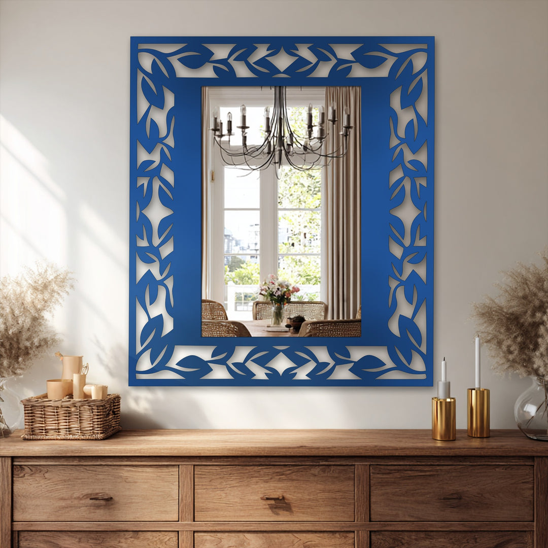 Rhythmic leaf pattern design evokes a sense of gentle metal wall decor fluidity as it surrounds the elegant botanical border design of this wall mirror.