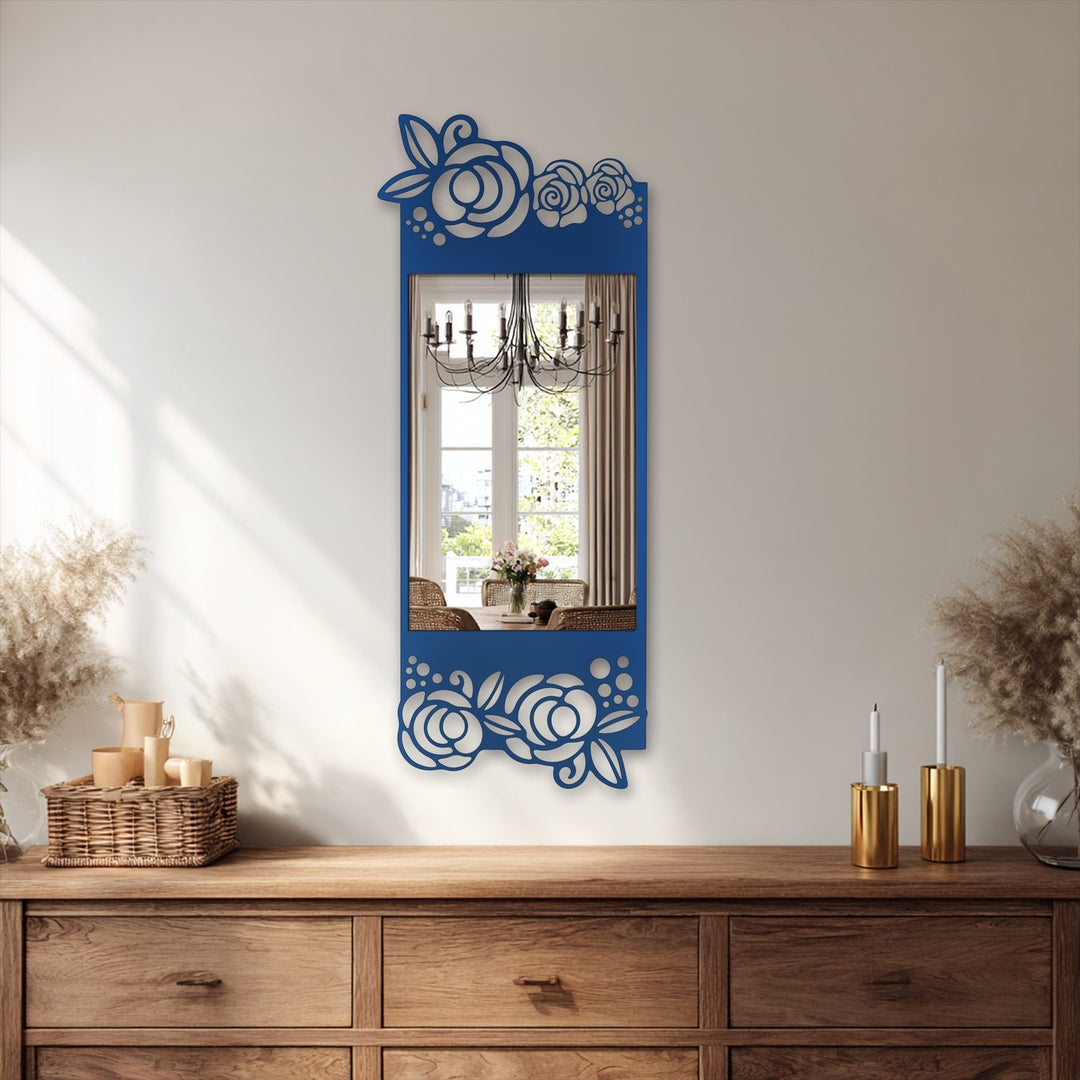 Framed by decorative geometric flower patterns, the blue mirror for wall decor reflects a bright dining area and chandelier with its rectangular design.