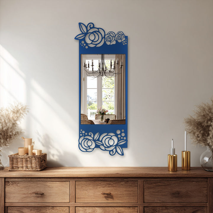 Framed by decorative geometric flower patterns, the blue mirror for wall decor reflects a bright dining area and chandelier with its rectangular design.