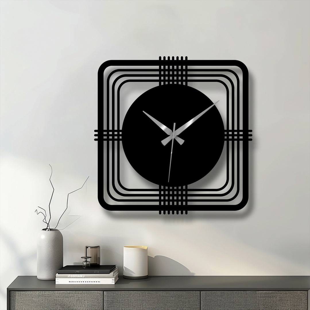 Highlighting the geometric elements, a modern metal wall clock features a square frame and circular face, showcasing decorative metal art with clean lines and a minimalist design.