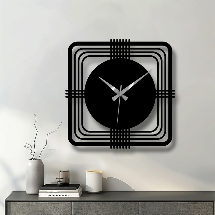 Highlighting the geometric elements, a modern metal wall clock features a square frame and circular face, showcasing decorative metal art with clean lines and a minimalist design.